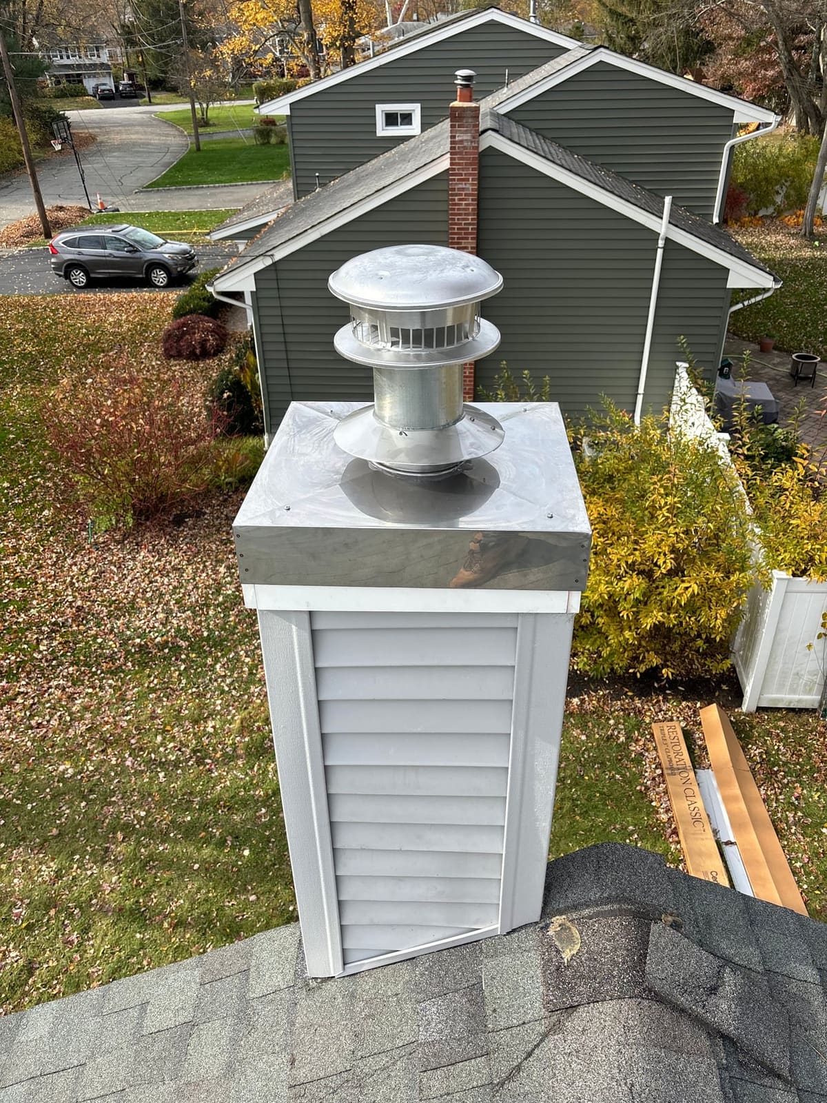 Framed chimney chase with a new stainless chase cover and cap