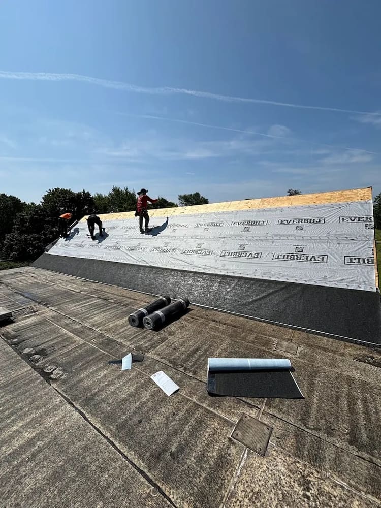 Flat roof membrane being installed on a low-slope roof