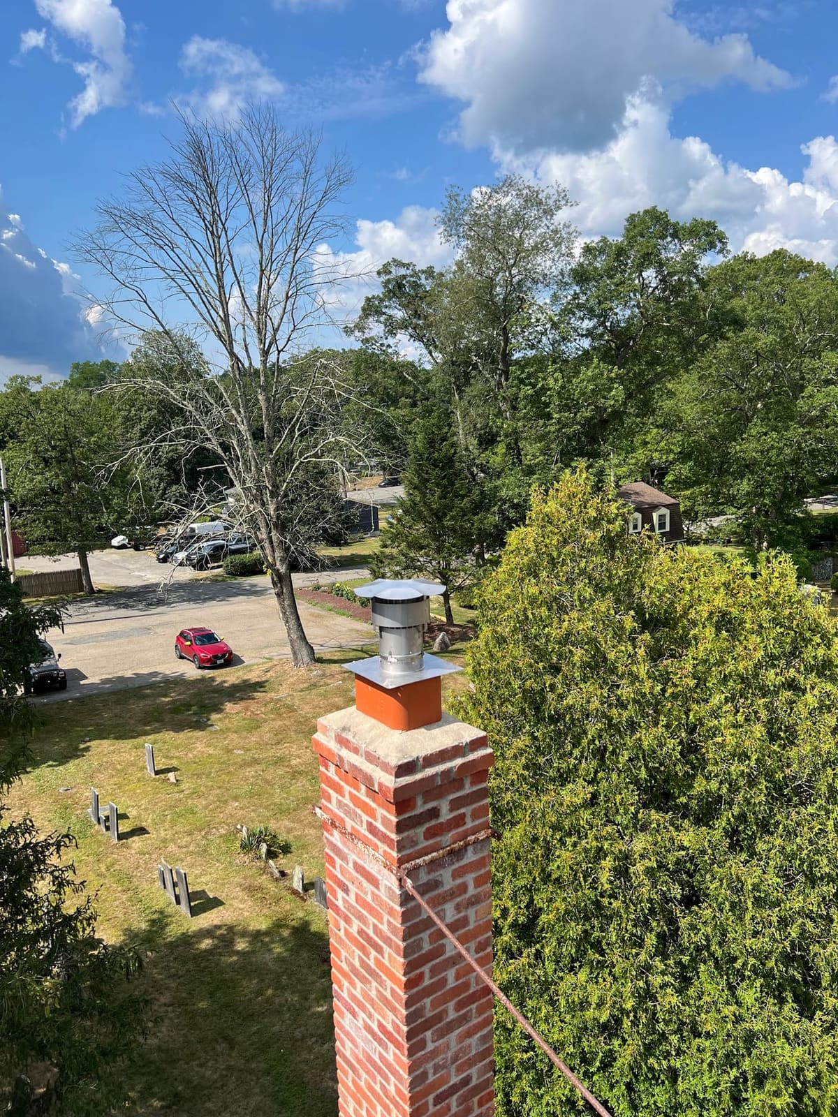 Rebuilt brick chimney and new cap seen from the roof