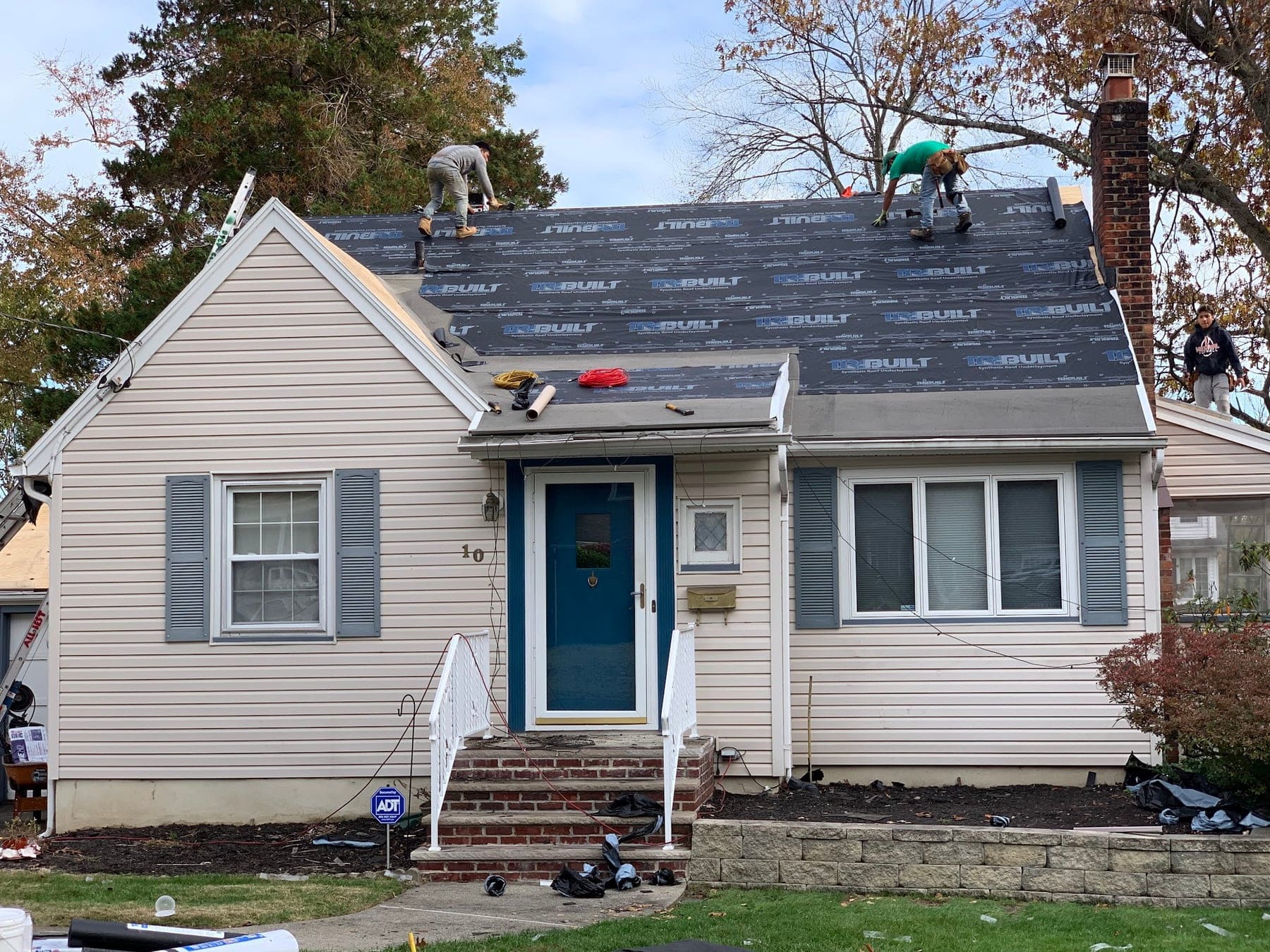 Roof replacement in progress on a Cape Cod style home