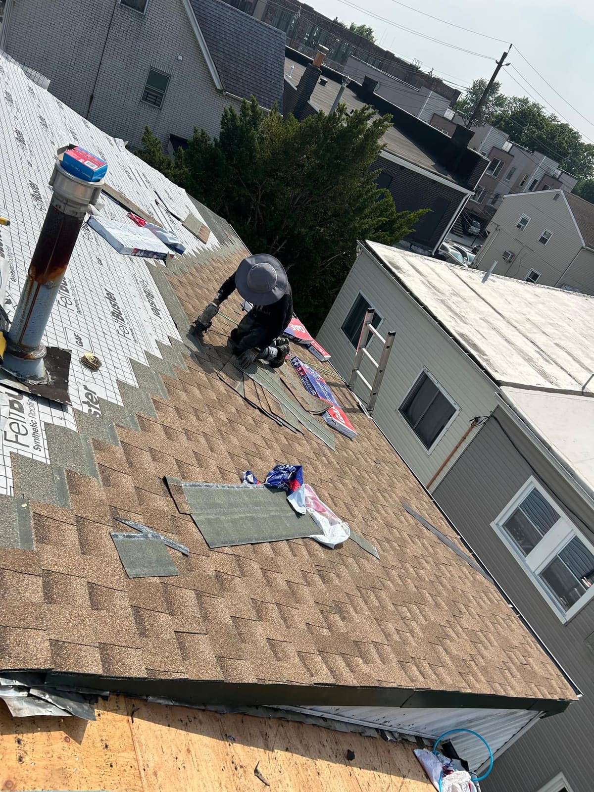 Shingles installed around a roof vent with new underlayment