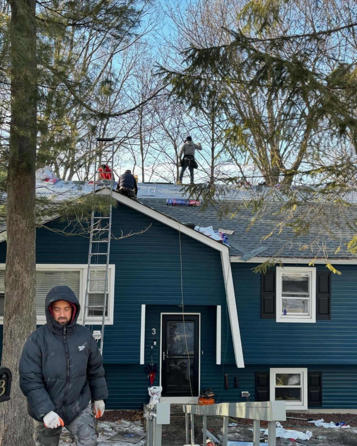 Asset crew replacing a roof in winter conditions